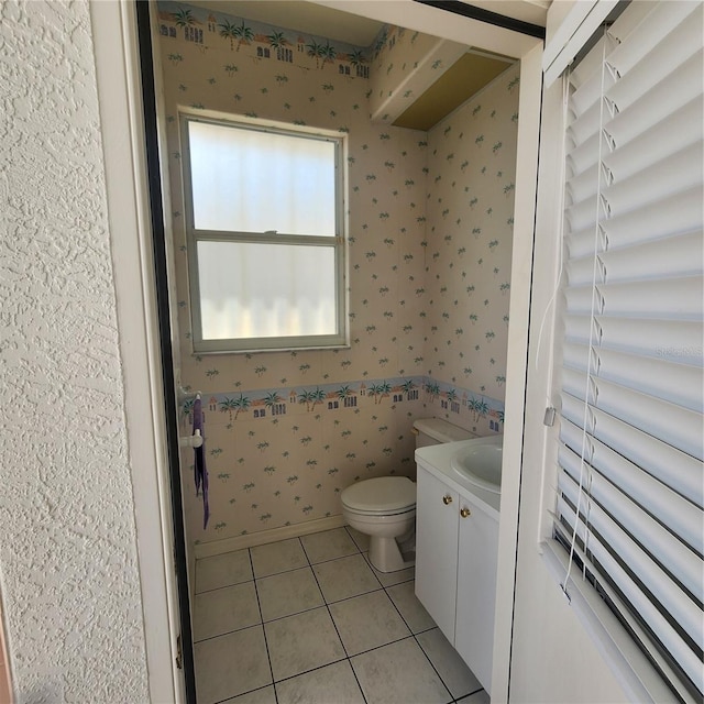 bathroom featuring vanity, tile patterned floors, and toilet