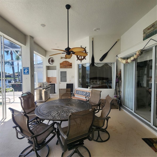 view of patio with ceiling fan and area for grilling