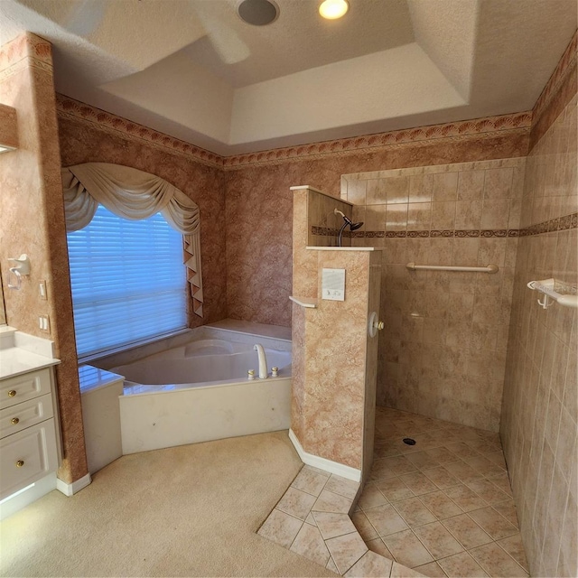 bathroom with vanity, plus walk in shower, a textured ceiling, and tile patterned floors