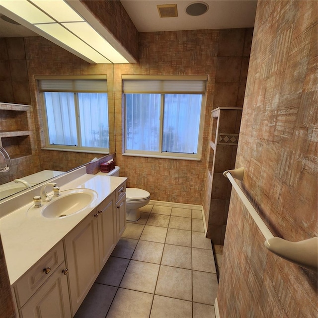 bathroom featuring vanity, tile patterned floors, toilet, and tile walls