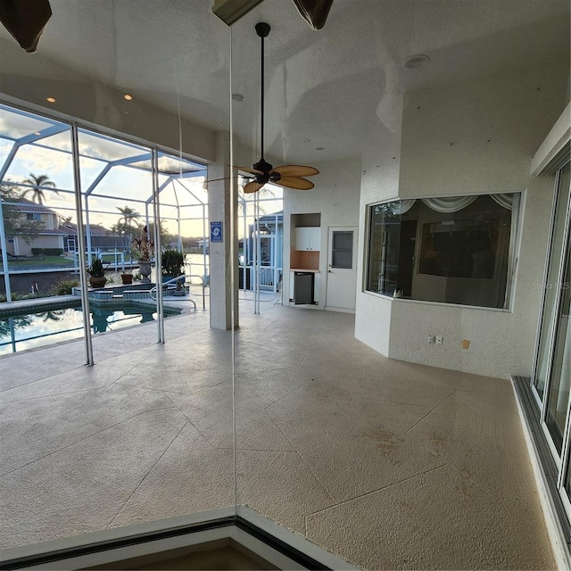 unfurnished living room with a textured ceiling and ceiling fan