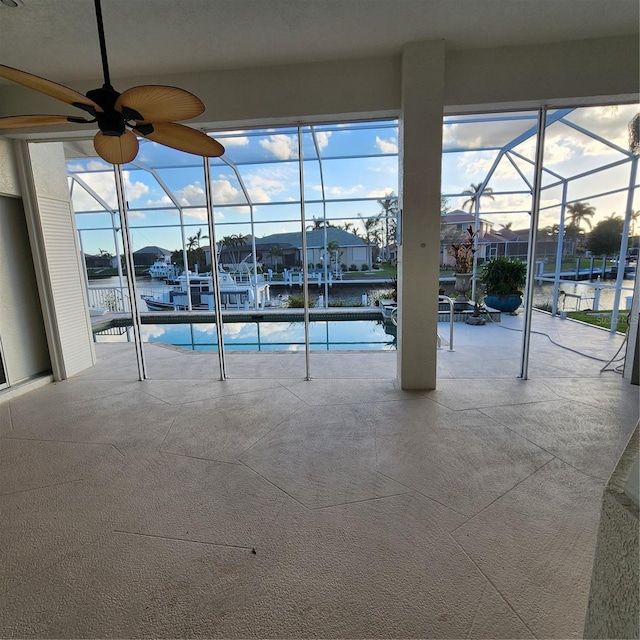 view of swimming pool with a water view and ceiling fan