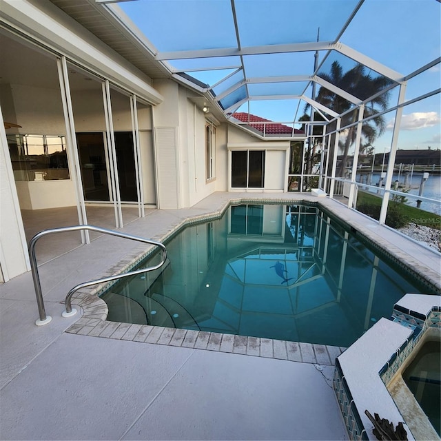 view of pool featuring glass enclosure and a patio