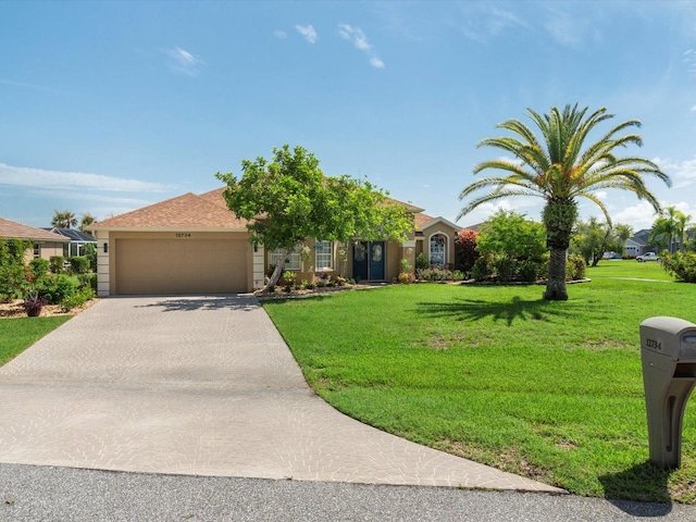 view of front of house with a garage and a front lawn