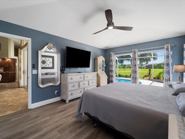 bedroom featuring a textured ceiling, hardwood / wood-style floors, access to exterior, and ceiling fan