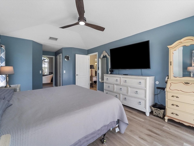 bedroom featuring ceiling fan, vaulted ceiling, and light wood-type flooring