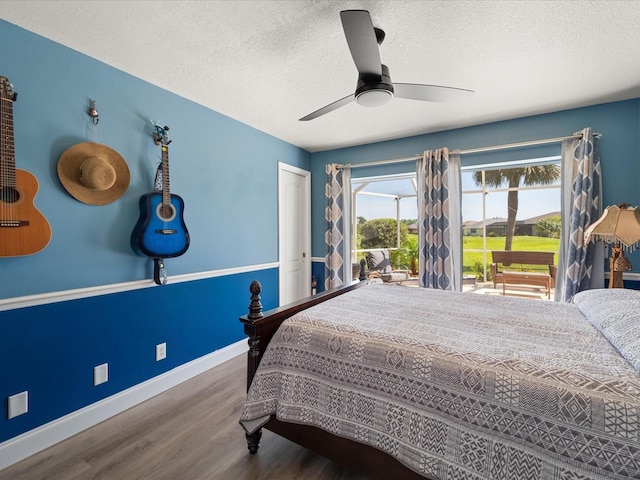 bedroom featuring hardwood / wood-style floors, a textured ceiling, and ceiling fan