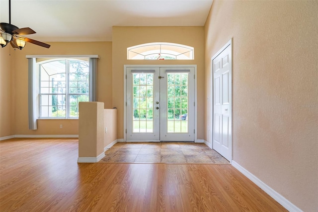 entryway with ceiling fan, light wood-type flooring, and french doors