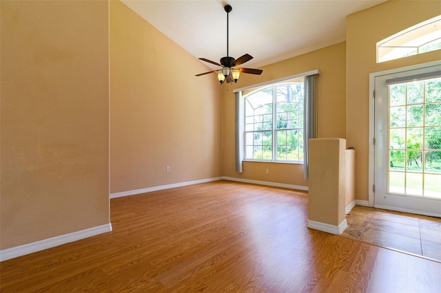 interior space with ceiling fan, lofted ceiling, and light wood-type flooring