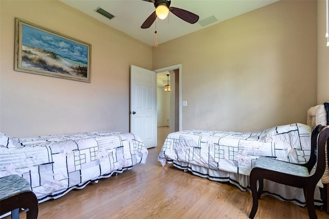 bedroom featuring hardwood / wood-style flooring and ceiling fan