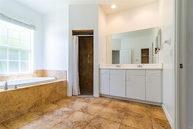 bathroom featuring vanity and shower with separate bathtub