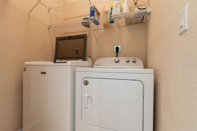 clothes washing area featuring separate washer and dryer