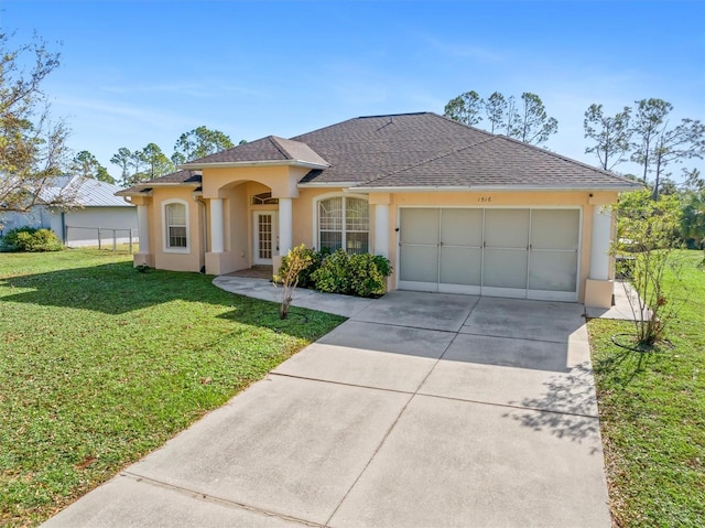 view of front of property featuring a garage and a front yard