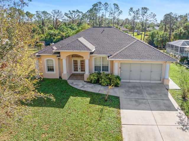 ranch-style house with french doors, a front yard, and a garage