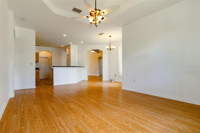 unfurnished living room featuring ceiling fan and light hardwood / wood-style floors