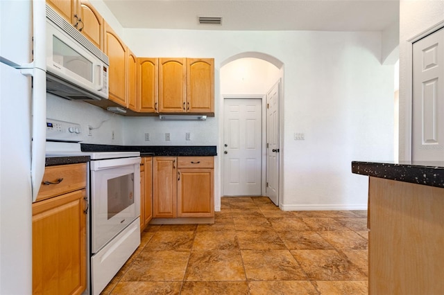 kitchen with white appliances and decorative backsplash