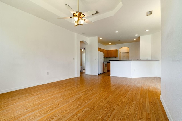 unfurnished living room with ceiling fan and light hardwood / wood-style floors