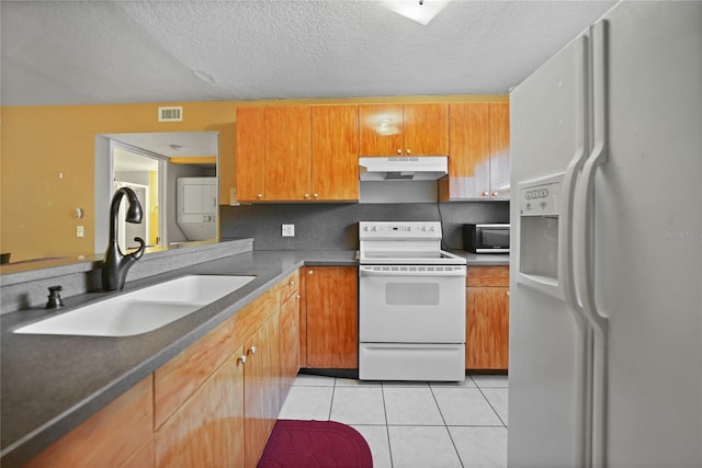 kitchen featuring light tile patterned flooring, sink, backsplash, white appliances, and a textured ceiling