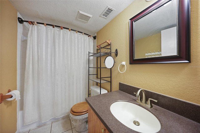 bathroom with tile patterned floors, toilet, a textured ceiling, and vanity