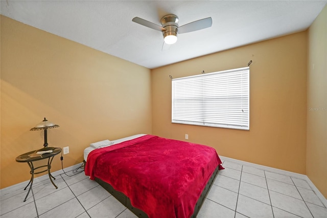 tiled bedroom featuring ceiling fan