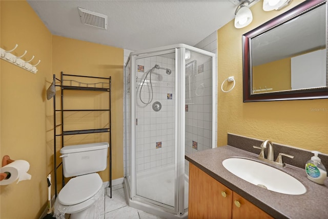 bathroom featuring vanity, a textured ceiling, tile patterned floors, toilet, and walk in shower