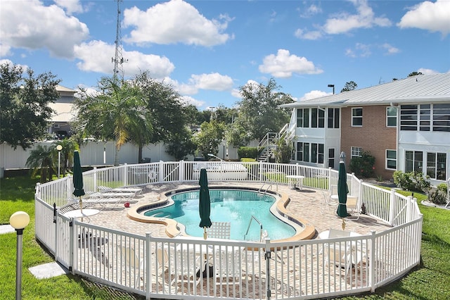 view of swimming pool with a patio