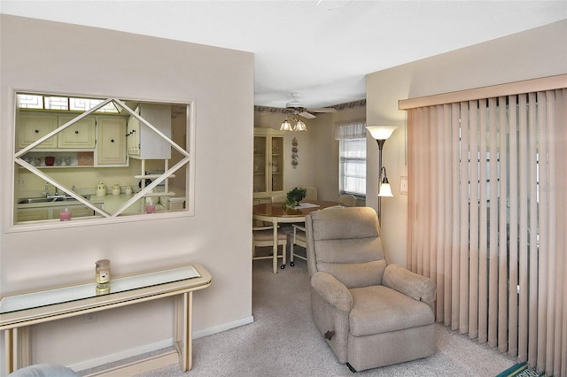 sitting room featuring carpet and ceiling fan