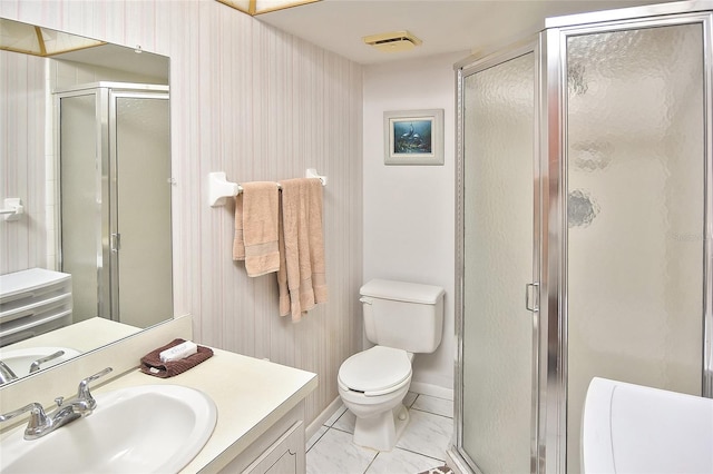 bathroom featuring a shower with shower door, tile patterned floors, vanity, and toilet