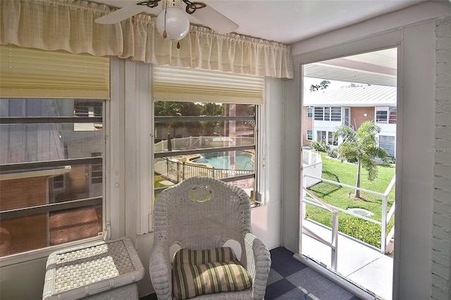 sunroom / solarium featuring a wealth of natural light and ceiling fan