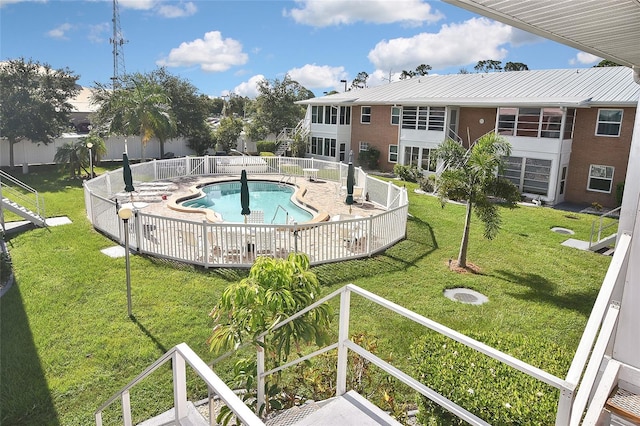 view of pool featuring a yard