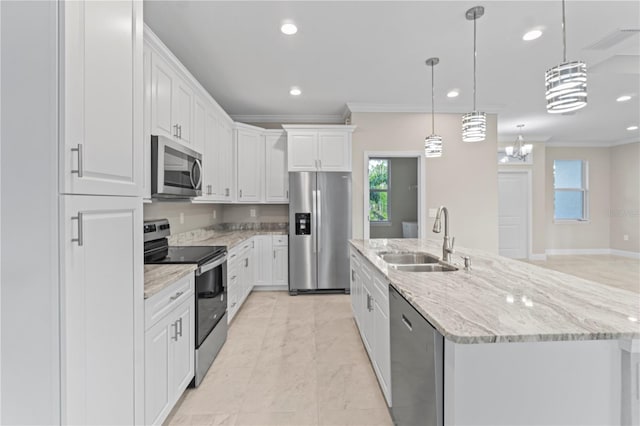 kitchen featuring stainless steel appliances, sink, white cabinetry, hanging light fixtures, and an island with sink