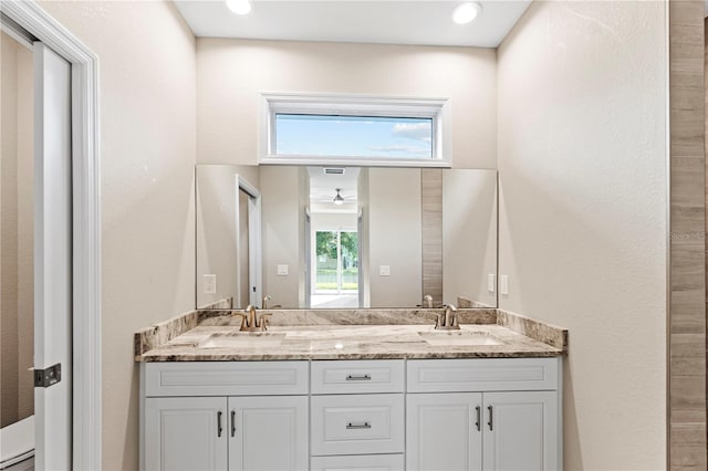 bathroom with ceiling fan, vanity, and a healthy amount of sunlight