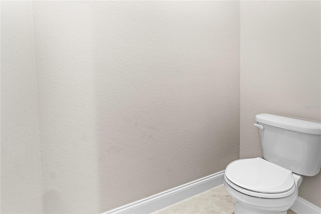 bathroom featuring tile patterned floors and toilet