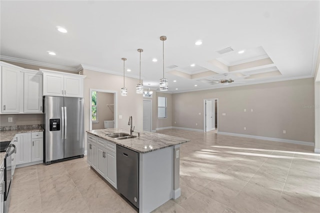 kitchen featuring appliances with stainless steel finishes, sink, a center island with sink, white cabinets, and hanging light fixtures