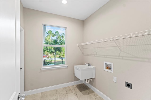 washroom featuring sink, washer hookup, and hookup for an electric dryer