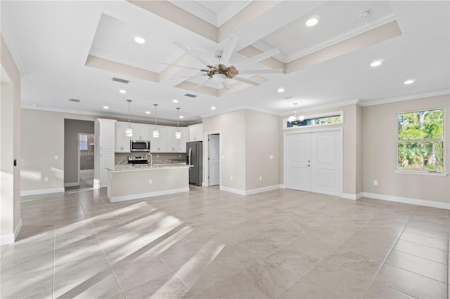 unfurnished living room with coffered ceiling, ceiling fan with notable chandelier, crown molding, sink, and beamed ceiling