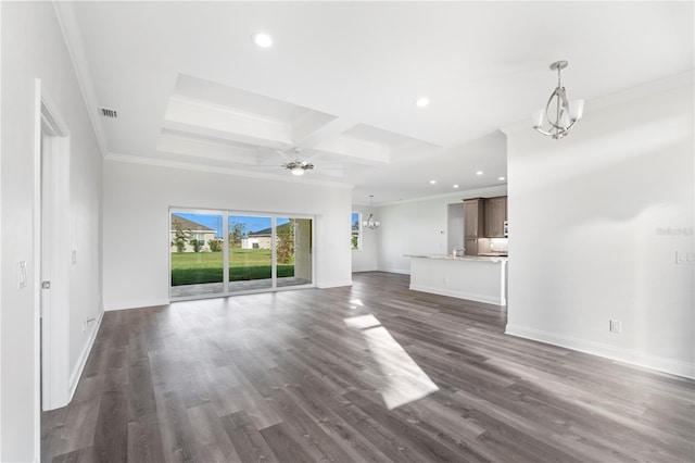 unfurnished living room featuring ornamental molding, dark wood finished floors, and ceiling fan with notable chandelier