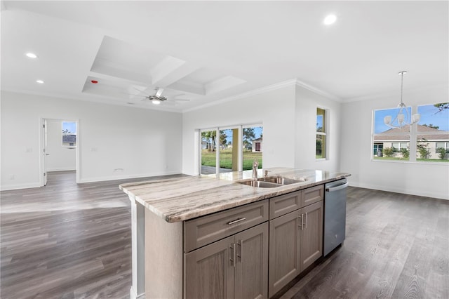 kitchen with a sink, open floor plan, light stone countertops, dishwasher, and an island with sink