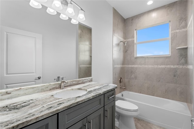 bathroom featuring toilet, shower / bathing tub combination, and vanity