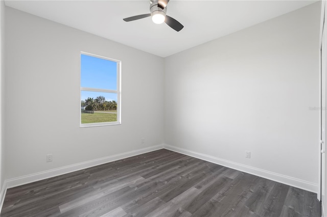 empty room with dark wood finished floors, baseboards, and ceiling fan