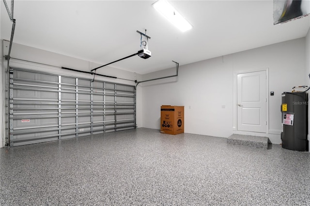 garage featuring a garage door opener and electric water heater