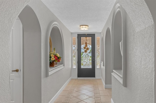 tiled foyer with a textured ceiling