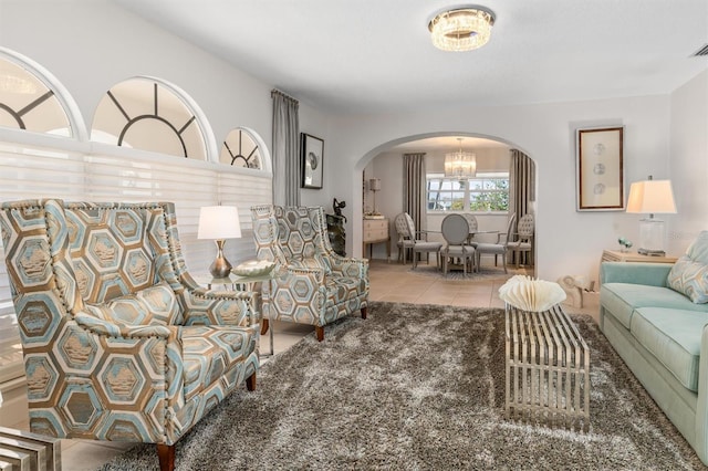 living room with a notable chandelier and light tile patterned floors