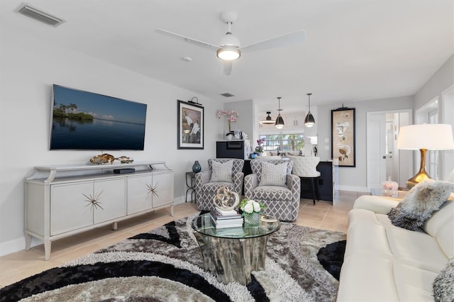 living room featuring ceiling fan and light tile patterned floors