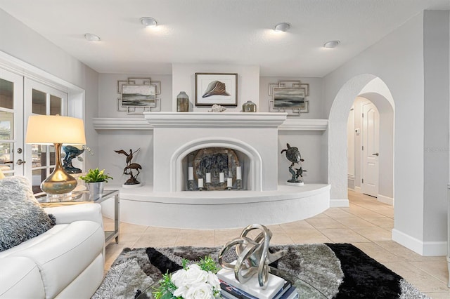 living room with french doors and light tile patterned floors