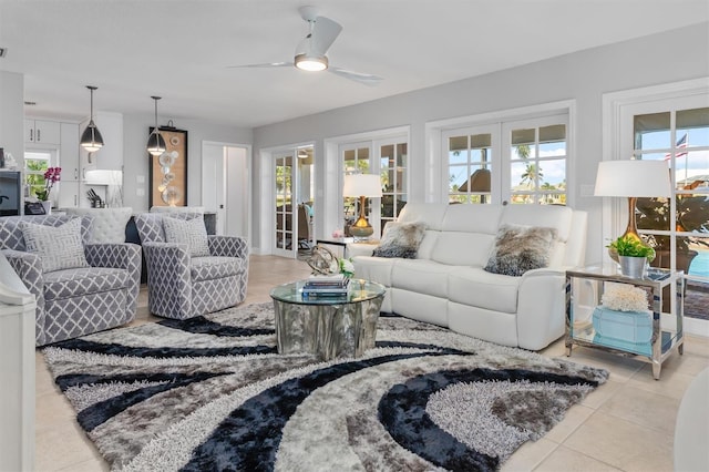 tiled living room with ceiling fan and french doors