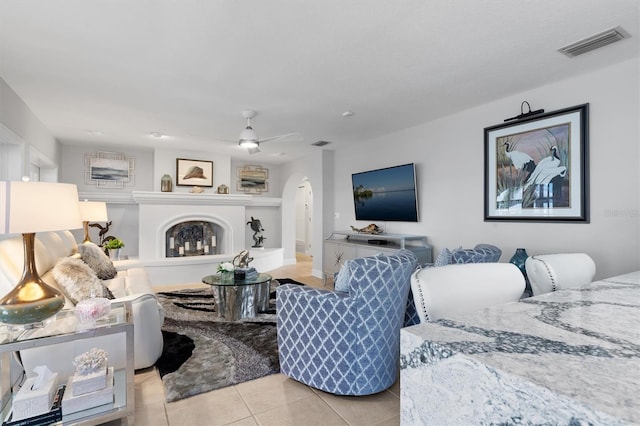 living room with light tile patterned floors and ceiling fan