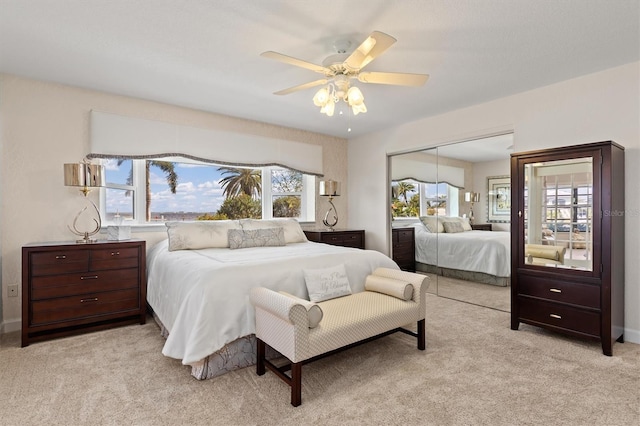 carpeted bedroom featuring a closet and ceiling fan