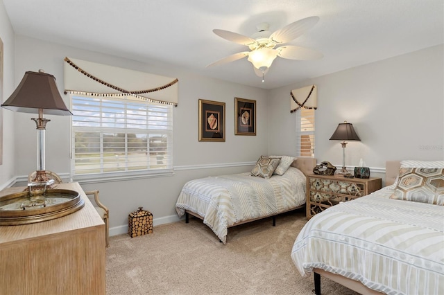 bedroom with light carpet and ceiling fan