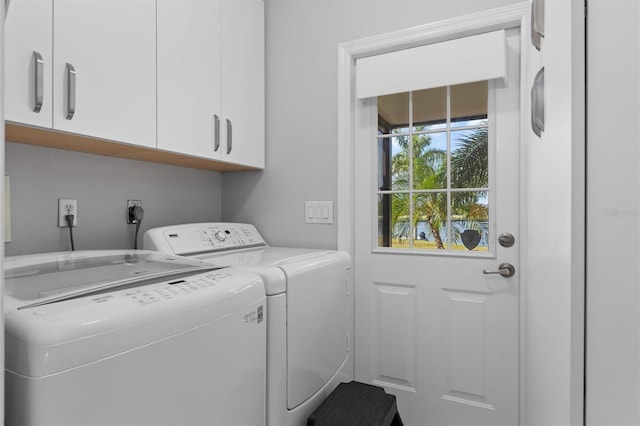 washroom with independent washer and dryer and cabinets